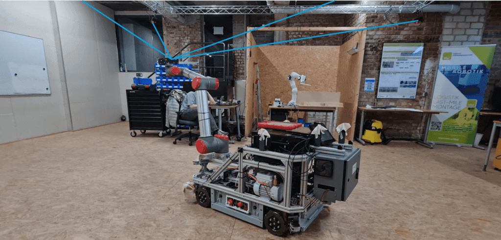 Mobile robot with robotic arm in the KaliMoRo lab — DTRACK cameras track the end effector